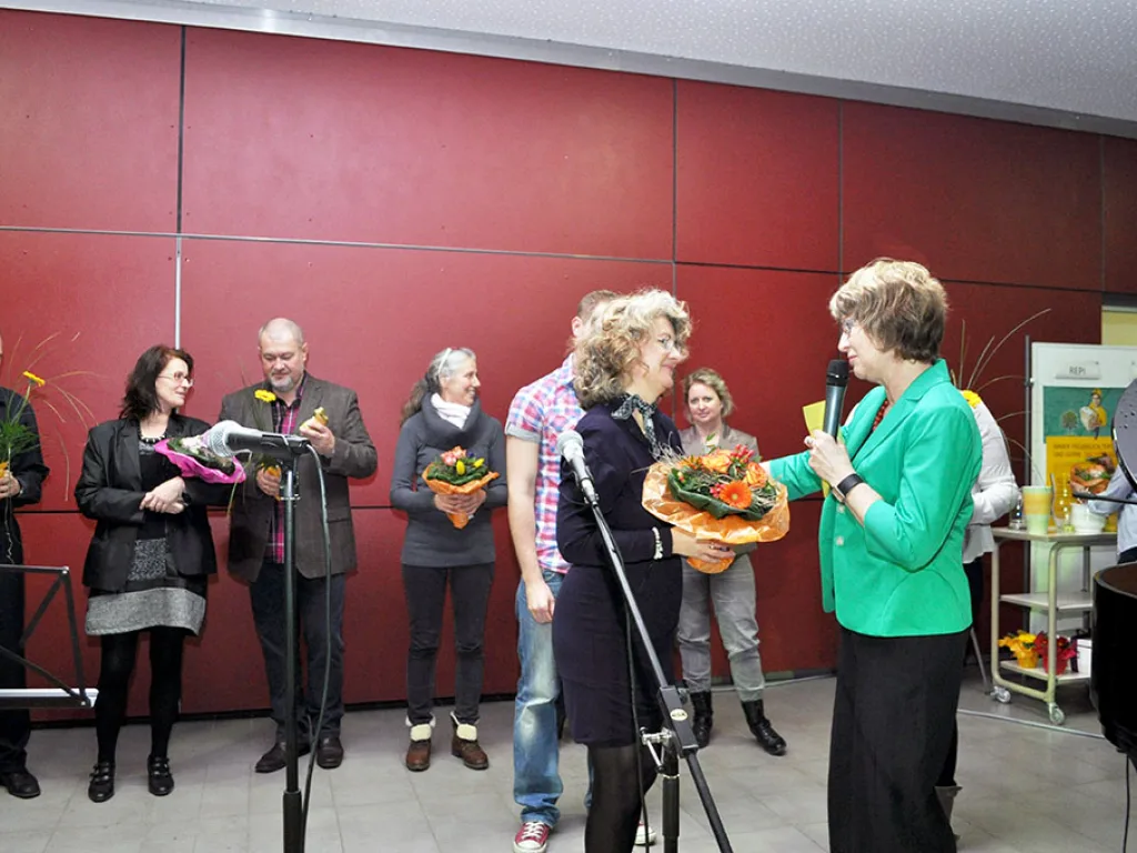 Übergabe von Blumensträußen bei der Veranstaltung.